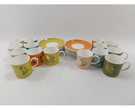 Susie Cooper coffee cans and saucers, decorated with floral sprays on vari-coloured grounds, comprising fifteen cups and sauc