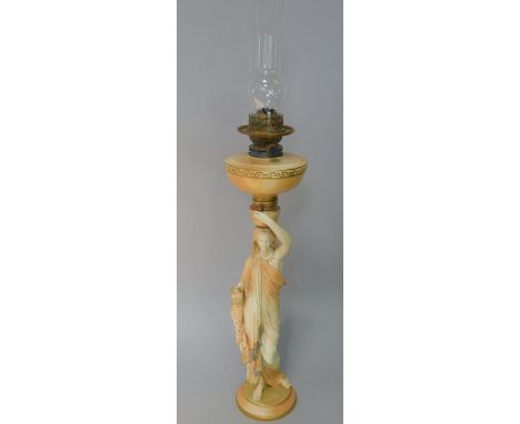 A Royal Worcester figural blush ivory oil lamp, in the form of a Grecian maiden with pitchers in a standing pose supporting t