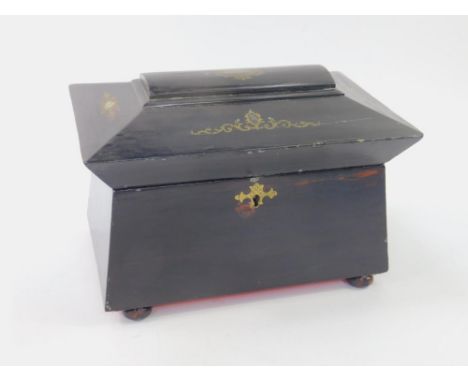 A Victorian ebonised twin division tea caddy, of sarcophagus form, with mother of pearl inlay and gilt transfer decoration, r