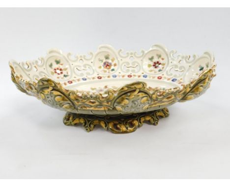 A Hungarian late 19thC oval shallow footed pottery bowl, possibly Zsolnay or Fischer, decorated internally with flowers, shap