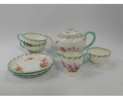 A Shelley porcelain tete a tete decorated with apple blossom, pattern no 13513, painted and printed marks, comprising tea pot
