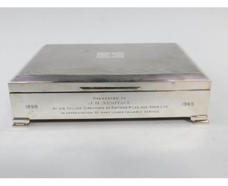 A silver rectangular cigarette box, with engine turned decoration, reserve presentation engraved, Birmingham 1964, 18.38oz al