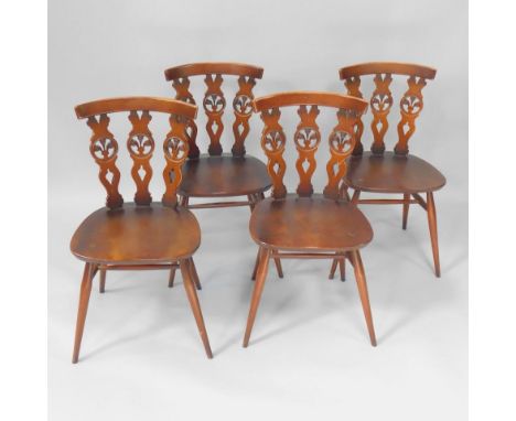 A set of four Ercol oak and elm kitchen chairs, with triple splat back enclosing Prince of Wales Feather, over a solid seat, 