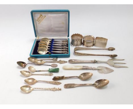 A pair of George III silver sugar tongs, with bright cut engraving, three napkin rings, commemorative silver and other spoons
