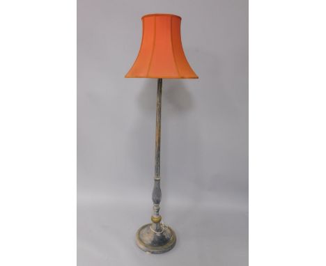 An early 20thC black and gilt painted standard lamp, of fluted baluster form, raised on a circular base and bun feet, with sh