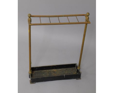 A Victorian cast iron and brass six division stick stand, raised on bracket feet.