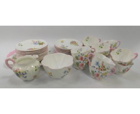 A Shelley porcelain tea service decorated in the Wild Flowers pattern, of fluted design, comprising twelve cups and saucers, 