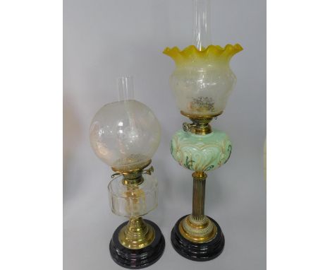 A Youngs Duplex brass oil lamp, with a green opalescent and painted glass reservoir, raised on a fluted column and turned soc