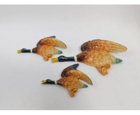 A set of three Sylvac pottery Flying Mallard wall plaques, graduated, impressed marks and paper labels.