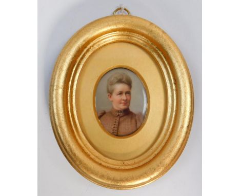 A portrait miniature of a Lady, hand painted on porcelain (possibly Meissen) inscribed Charlotte Greasley verso, 5cm x 3.5cm 