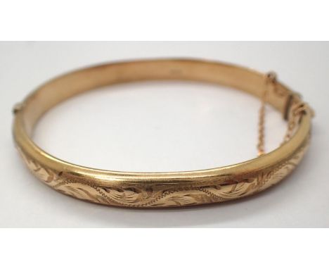 9ct gold engraved bangle with safety chain, D: 70 mm, 9.7g. P&amp;P Group 1 (£14+VAT for the first lot and £1+VAT for subsequ