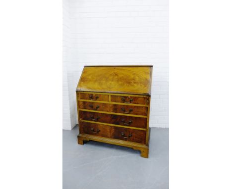 A 19th century mahogany bureau, the fall front opening to reveal a fitted interior over a pull out slide with two short drawe