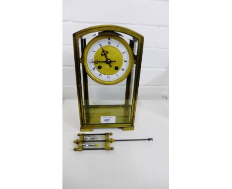 A French gilt metal dome cased mantle clock, the gilded and enamel dial with Roman numerals, having a mercury filled pendulum