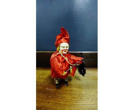 A German tin plate model of a clown playing a violin (key lacking), 12cm high