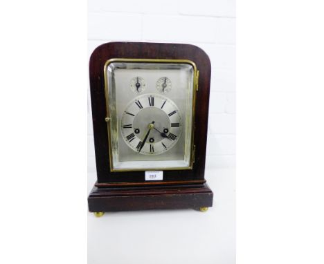 An Edwardian mahogany cased mantle clock with silvered dial and Roman numerals below  regulator and chime and silent dials, r