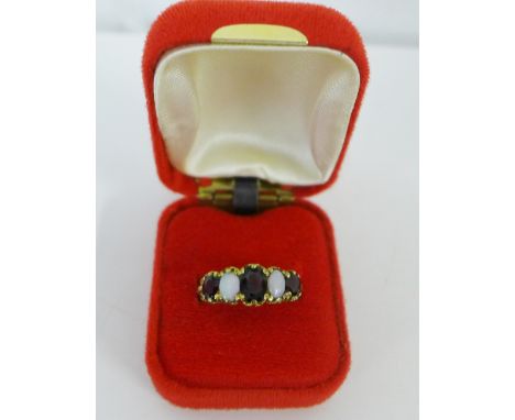 A 9 carat gold opal and garnet set dress ring, UK size O