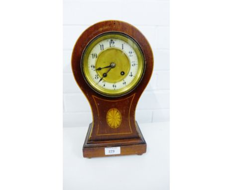 An early 20th century mahogany cased mantle clock, the enamel chapter ring with Roman numerals, raised on four bun feet, 33cm