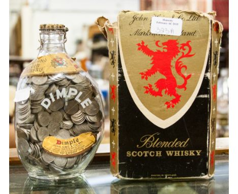  A dimple blended Scotch Whisky bottle full of 6d coins 