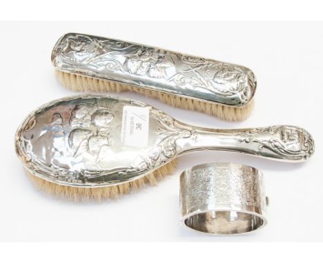 Two Birmingham silver backed hair and clothes brush and a silver cuff bangle, dated 1884 (3) 