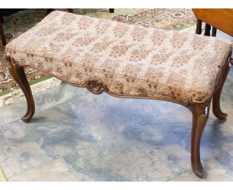A mid Victorian walnut duet piano stool, raised on French cabriole legs