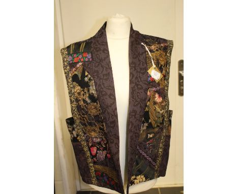 A sage green self patterned kimono style jacket with patch pockets and heavily embellished jacket with patchwork design (beau