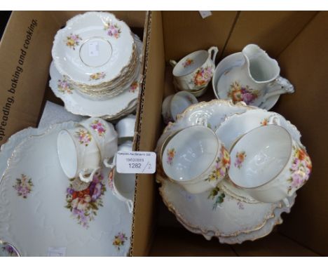 A 19th Century German porcelain tea service (38 pieces) and two dessert stands and a serving plate (Limoges) in two boxes 