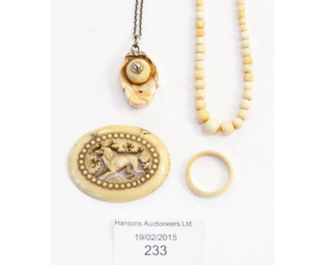 A collection of Ivory jewellery, comprising a carved oval depicting a dog, a graduated bead necklace, a band ring, plus a pen