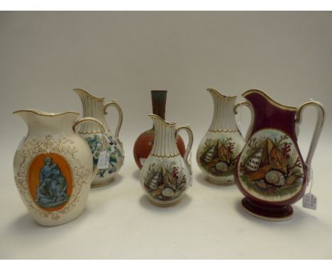 A collection of Prattware jugs including shell decorated baluster jugs on white and maroon grounds, together with an enamelle