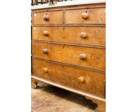 A George III oak chest of drawers, fitted with two short over three long graduated drawers, raised on bracket feet