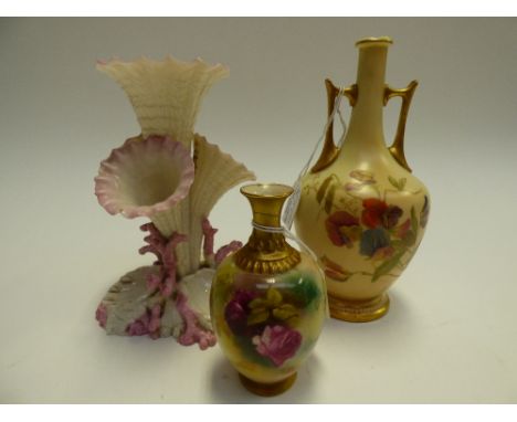 Two Royal Worcester blush ivory vases (af) together with a Belleek posie vase of multiple trumpet form (af) 