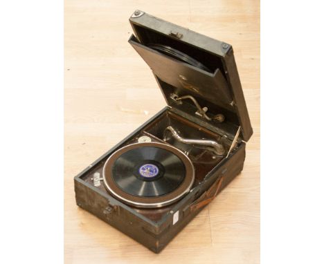 An HMV model 101 record player with records 