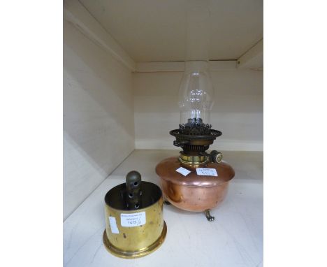 A copper oil lamp and glass funnel with 1959 submarine part shell 