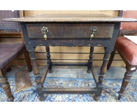 An early 18th Century oak side table, fitted with a single drawer, raised on baluster and ring turned legs, united by square 