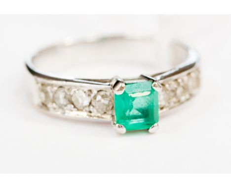 An emerald and diamond ring, stamped 14k 