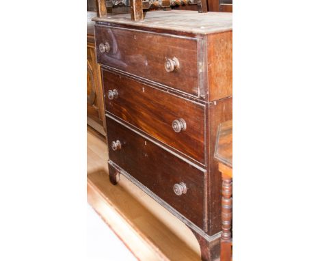 A George III mahogany secretaire, circa 1810, originally fitted with an upper section, raised on bracket feet