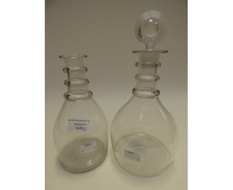 Two George III triple ring neck decanters, one retaining it's original stopper (2) 