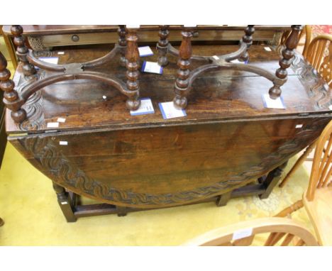 A late 17th Century oak gateleg table, the later carved plank top raised on baluster and ring turned legs, originally having 
