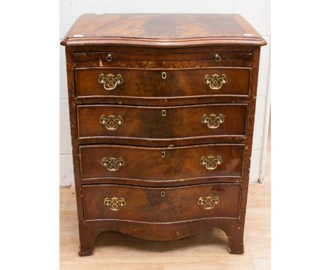 A George III style mahogany chest of drawers of serpentine form fitted with a brushing slide to top over four graduated drawe