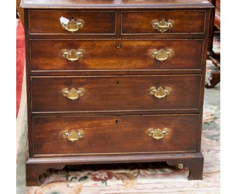 A George III mahogany chest of drawers, comprising two short over three long graduated drawers, raised on bracket feet