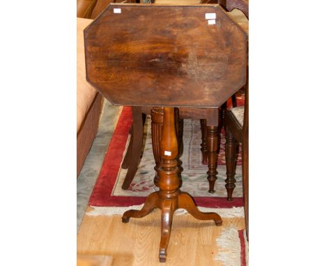 An early 19th century mahogany tilt top tripod table, the oblong octagonal table raised on a baluster and ring turned column,