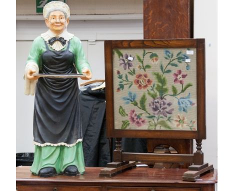 A 20th Century shop display figure in the form of an old woman; together with a tapestry folding table 