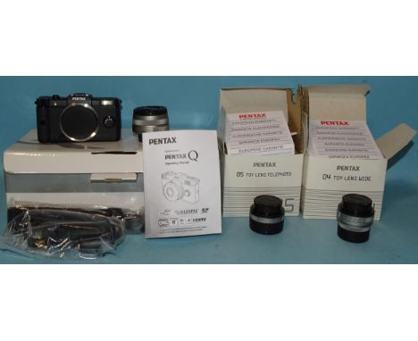 A Pentax Q sub-miniature digital camera with O1 standard prime f1.9 8.5mm lens, manual and accessories, (boxed) and two furth