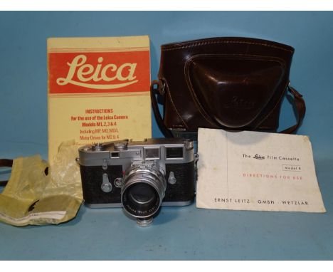 A Leica M3 Rangefinder camera, serial no. 901021, 1957, with Summicron f1.2 5cm lens no. 1511497, body cover, instruction man