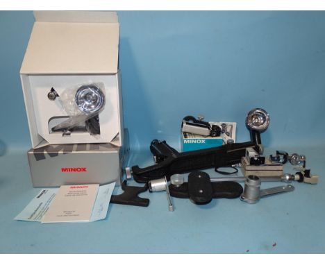 A Minox flash, (boxed with instructions), another, (no box) and other Minox accessories. 