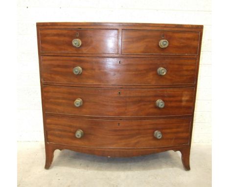 An early-19th century mahogany bow-front chest of two short and three long drawers, on bracket feet, 106cm wide, 106cm high. 