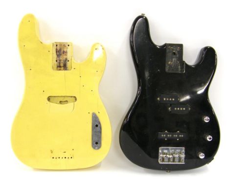 Two old bass guitar bodies, one vintage Precision style with blonde finish, the other a Precision/Jazz bass hybrid with black