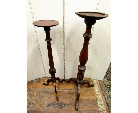 A 19th century mahogany torchere on a fluted vase shaped column and tripod base and one other smaller similar