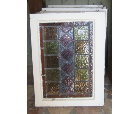 Eight reclaimed 1930s painted pine framed casement windows, with coloured leaded light panels, the outer frames 56 x 42cm