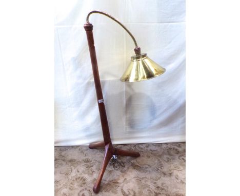 An unusual low hardwood floorstanding standard lamp with adjustable coiled neck and conical shade raised on a moulded stem an