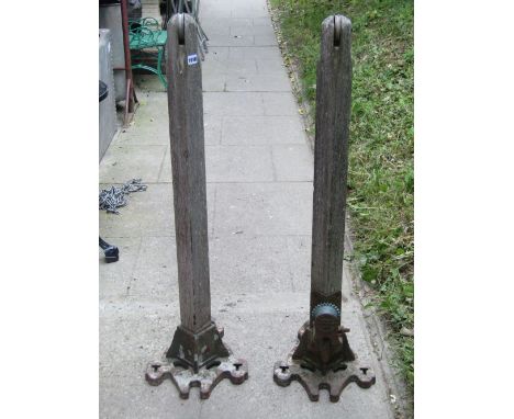 A pair of weathered vintage lawn tennis posts with cast iron bases, stamped F H Ayres Championship tennis post
